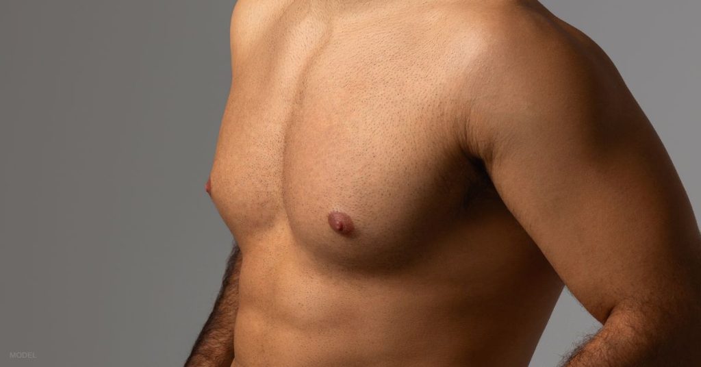 A close up of a man's chest. (Model)